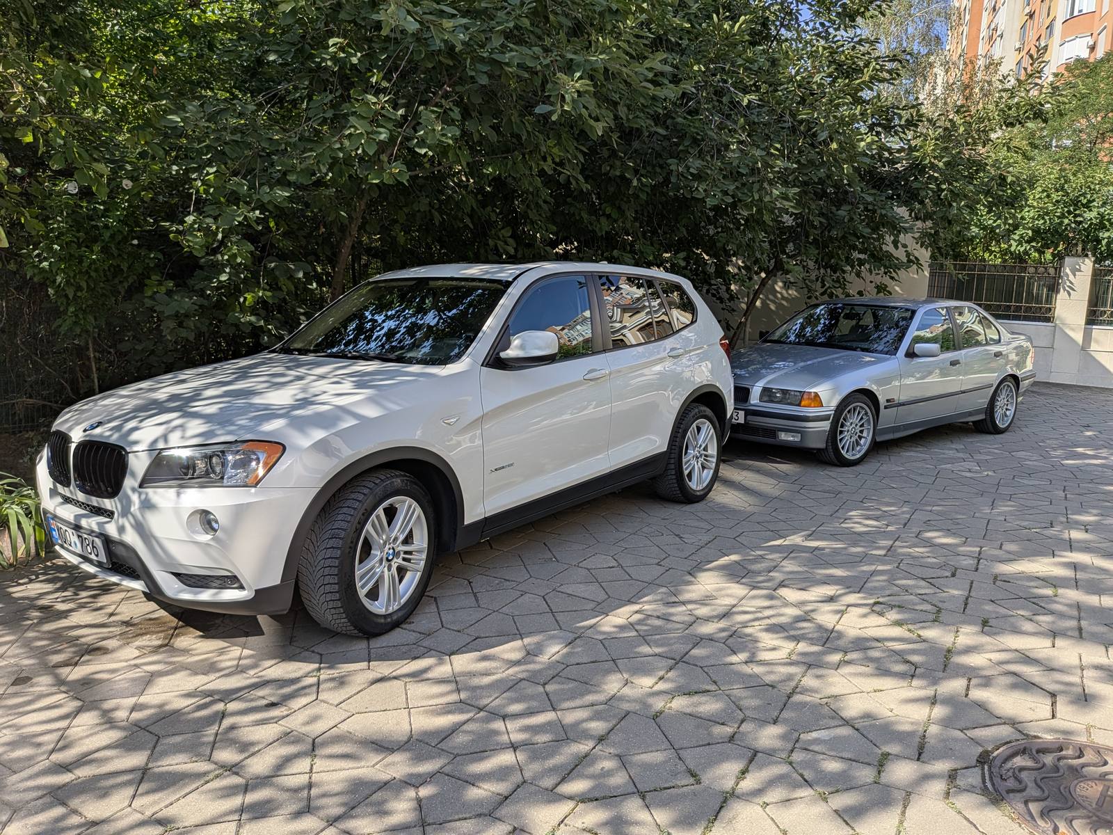 The X3 parked next to a BMW E36, in the same yard