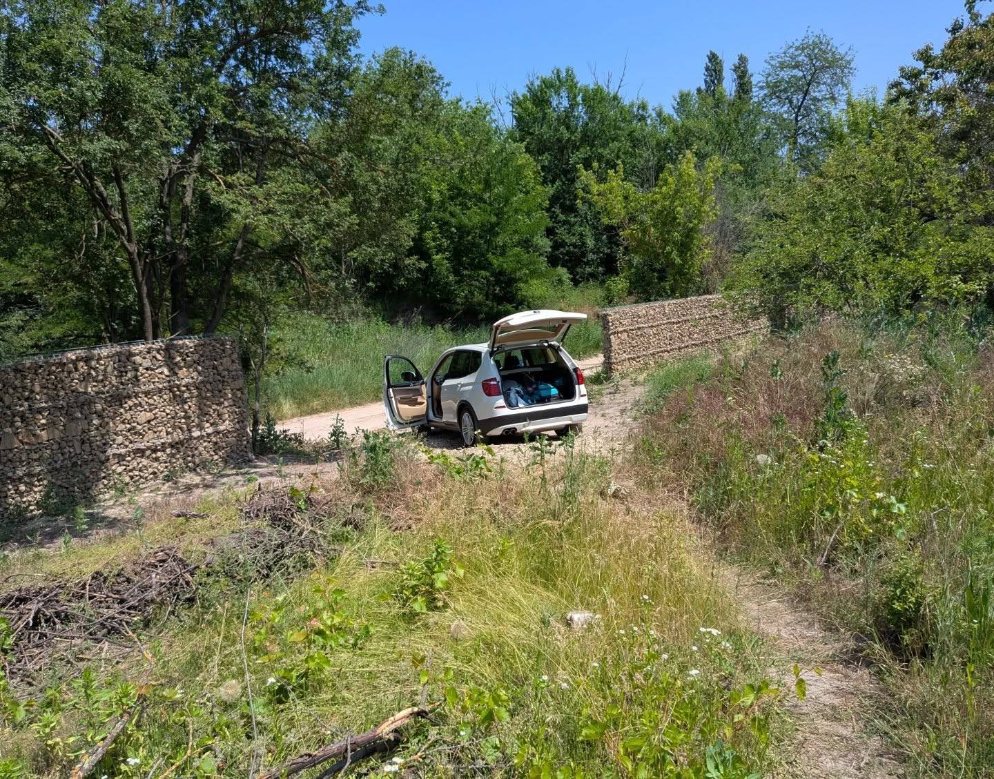 The X3 with the tailgate open on a country road