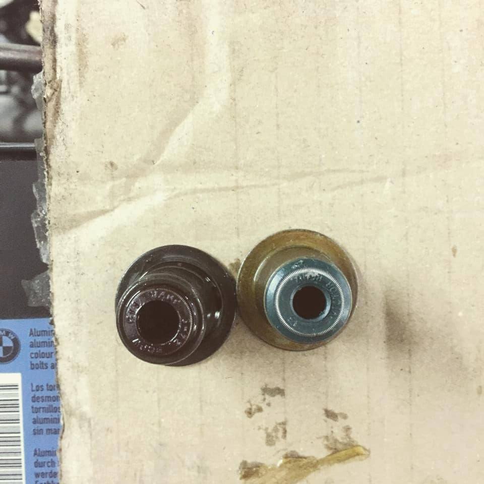 An old valve stem seal next to a new one
