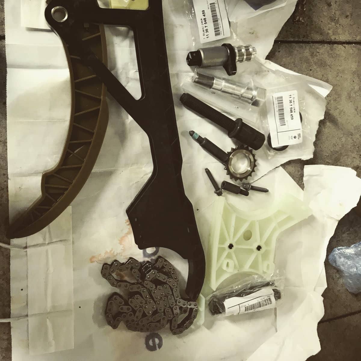 The timing chain kit laid out on the bench