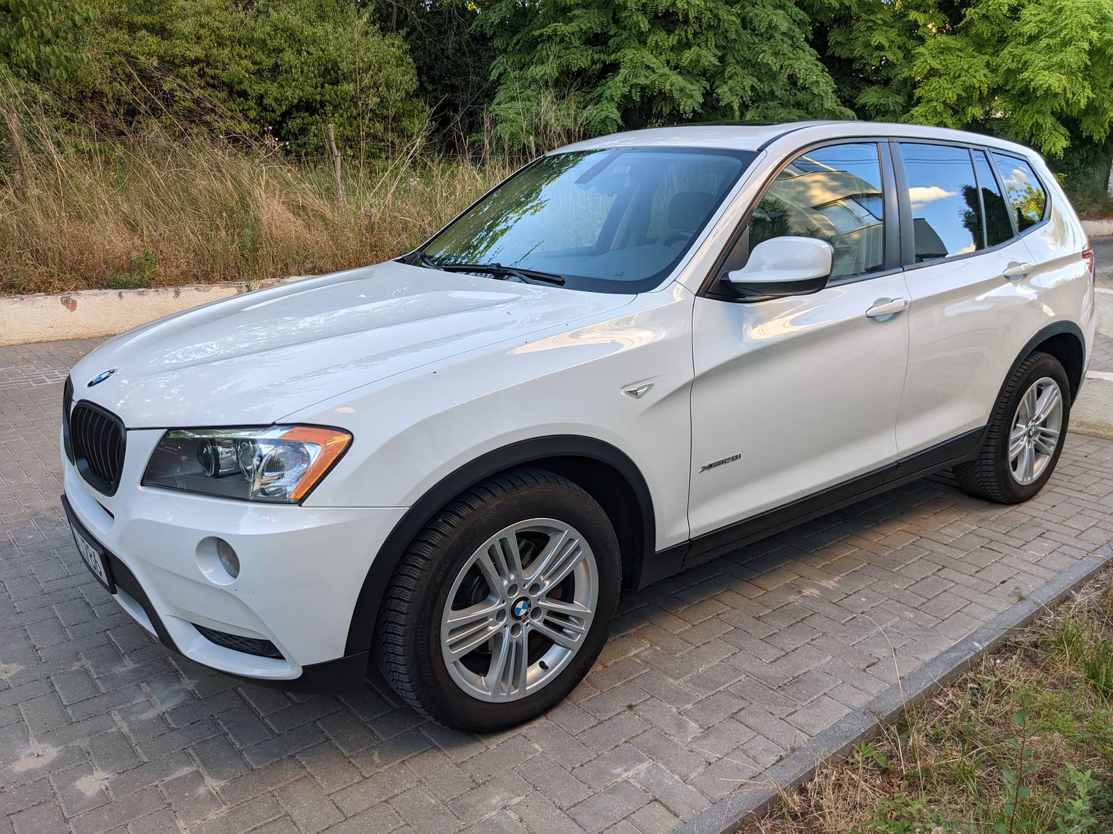 X3 from the front, in a car park, on a July evening