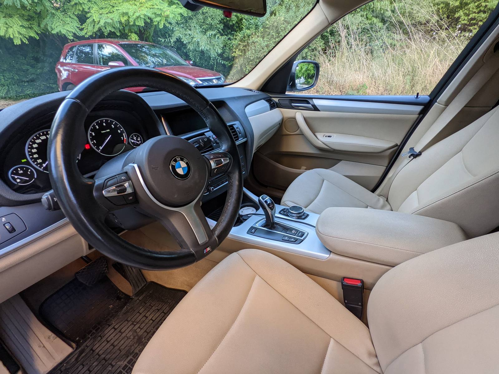 The beige interior with the M steering wheel