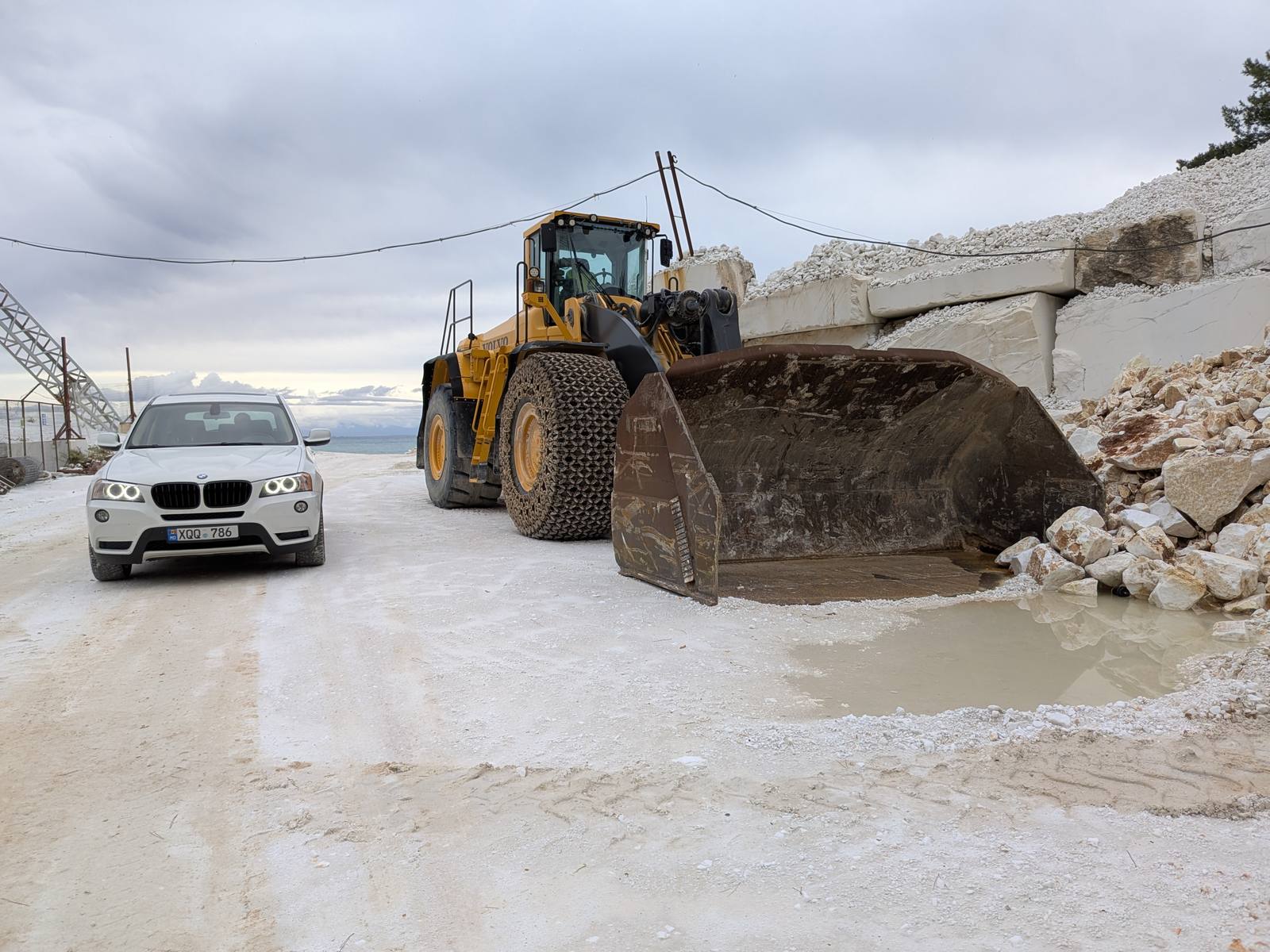 X3 in the marble quarry next to a loader