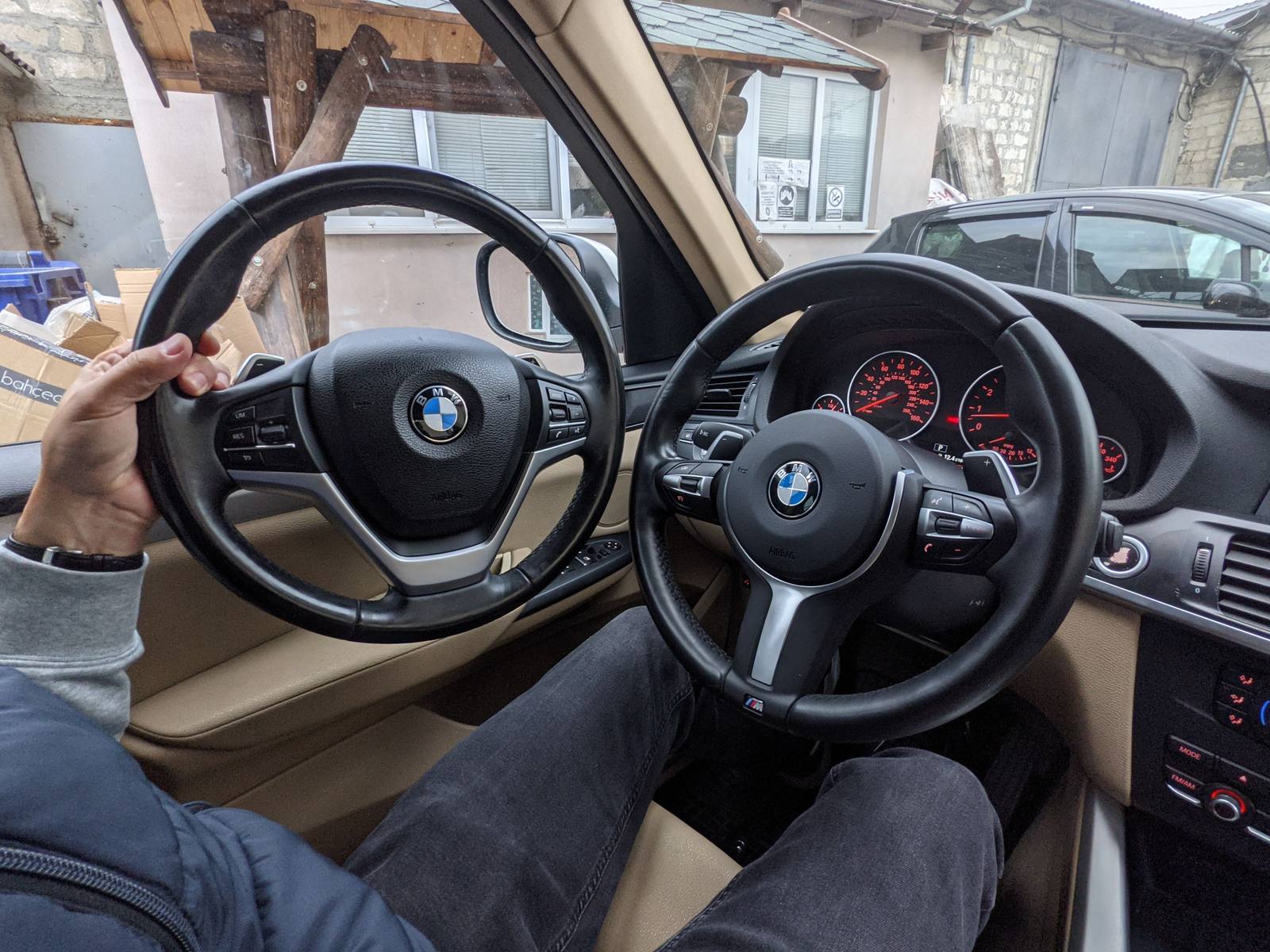 The two steering wheels, standard and M, side by side