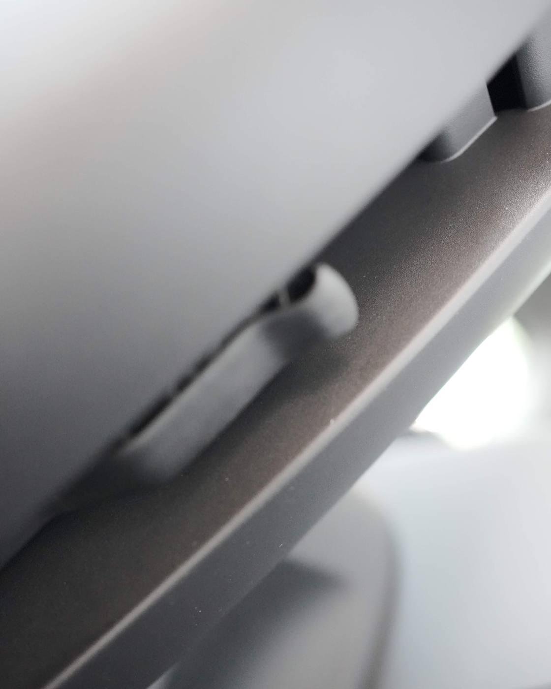 The mechanical steering adjustment lever under the column, up close