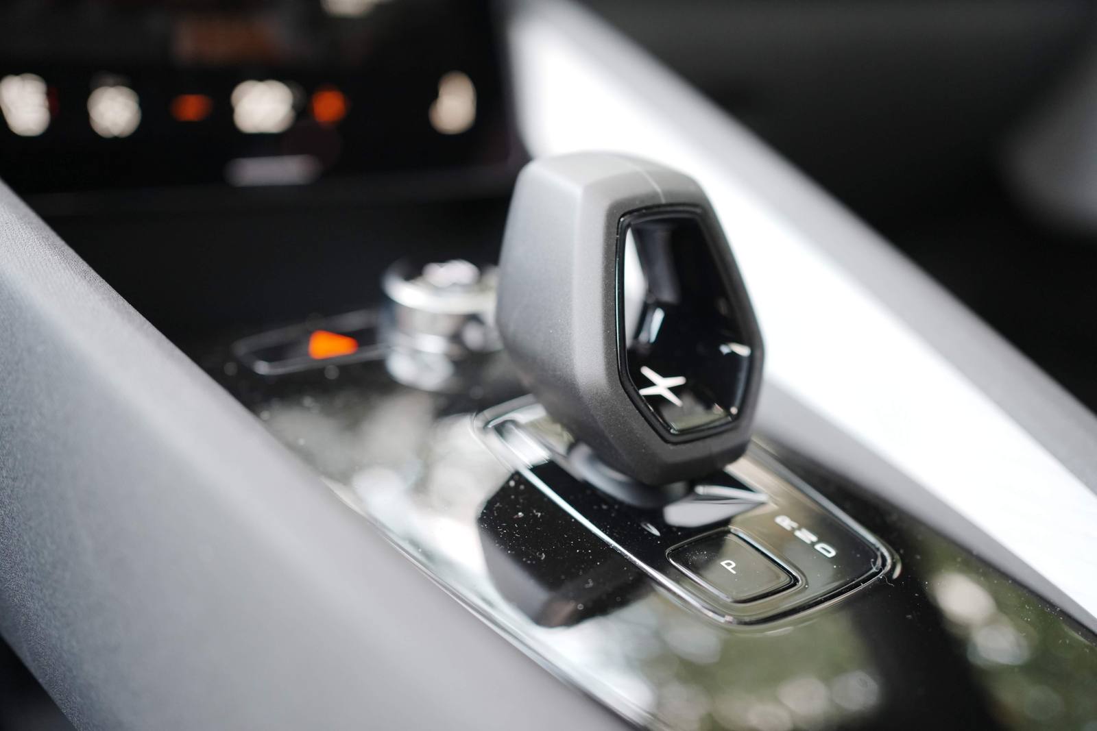 The gear selector on the console and the separate P button at its base