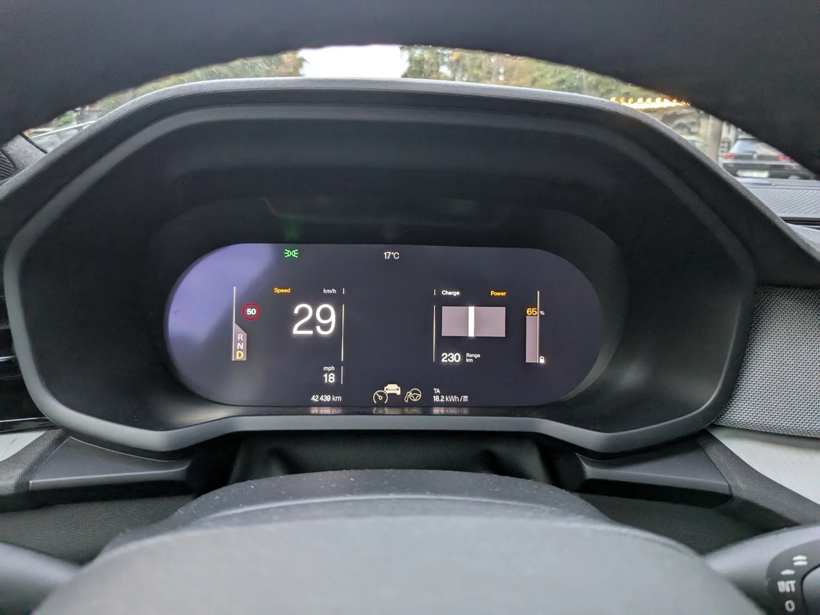 The Polestar 2 driver display in Calm mode, at 29 km/h, seen through the steering wheel